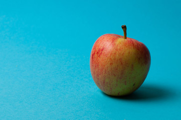 Apple on a blue background. Healthy eating, calorie count and weight loss concept