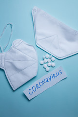 pills and protective mask on a blue background