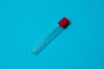 One blood collection tube on a blue background