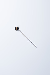 High angle view of dental instrument with mirror for teeth examination on grey background