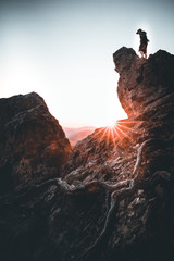 Man on top of mountain watching the sunset