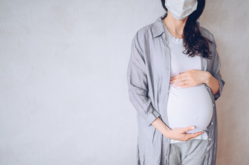 Sad pregnant woman wearing medical face masks due to illness, dizziness against infectious diseases and flu. Healthy pregnancy concept. Pregnancy And Infection. Copy space mock up. White background