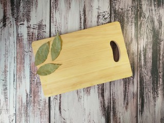 Bay leaf on a wooden chopping Board with a textured wooden table background, copy space, cooking...