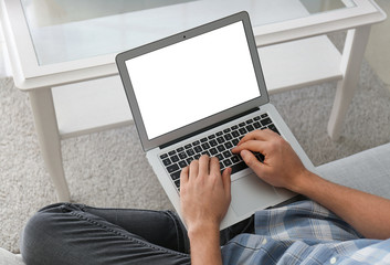 Handsome man with laptop at home