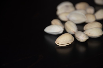 Fototapeta na wymiar Pistachio nuts on black background