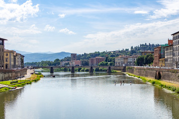 Naklejka premium Nice view of Arno river in Florence Italy with SUP surfing people
