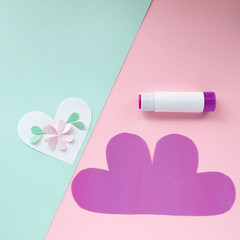 Step by step children's cardboard crafts for mothers day- pink flower on a purple heart shaped sheet. Scissors, glue, paper sheets. Children activity in kindergarten, school, at home. Step 5