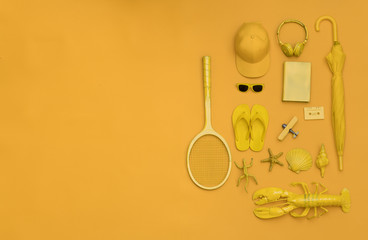 tennis racket and beach accessories on an orange background