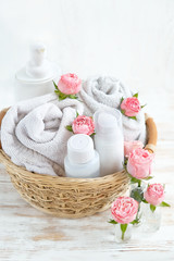 Beauty care cosmetic products. spa healing procedures. bottles, towels and rose flowers