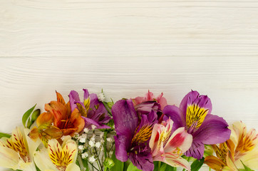 Bouquet of alstroemeria flowers on a white wooden table. Holiday, gift.