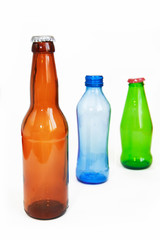 blue, green, brown glass beverage bottle on white background