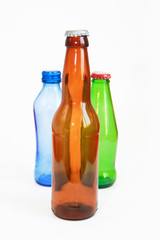 blue, green, brown glass beverage bottle on white background