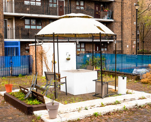 The community garden. 
Color picture who depicts an empty and dilapidated community garden of London.
