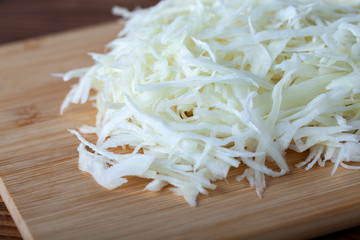 Sliced cabbage on a wooden cutting board