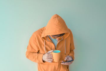 Man drinking coffee and using mobile phone in morning