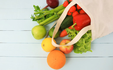 Eco bag with vegetables  on blue wooden background,copy space