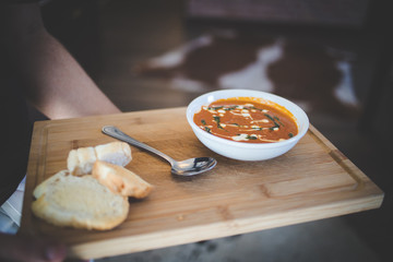 Close up image of a stunning tomato soup being served in a gourmet restaurant