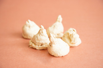 Homemade baked meringue cakes on the pink background