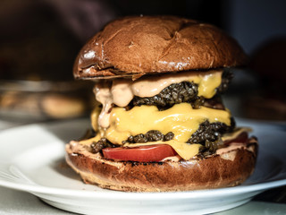 Juicy, delicious homemade beef burger with a lot of cheddar.