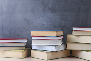 Stacks of books several on a gray background close-up. Back to school, education, learning,