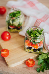 Healthy Homemade Jar Salad with cucumbers and tomatoes. Healthy food, Diet, Detox, Clean Eating or Vegetarian concept.