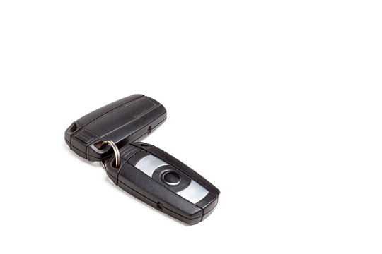Car key, a second-hand keychain with a chip and with buttons for opening and closing the central locking control, isolated on a white background in a photo studio.