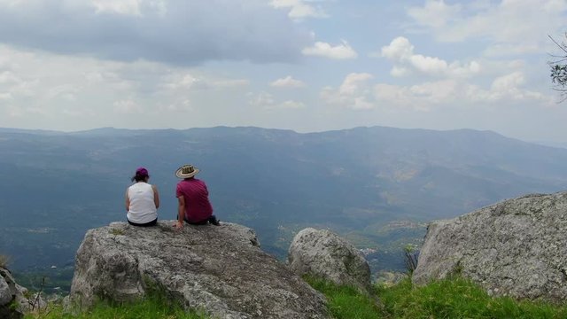couple enjoying the magnificent view from El Chapo. Andean mountains and valley