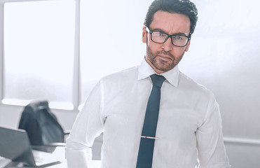 confident businessman standing in a spacious office