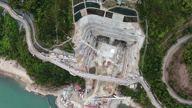 Aerial view of a mega scale tunnel road construction sire in Hong Kong bay.