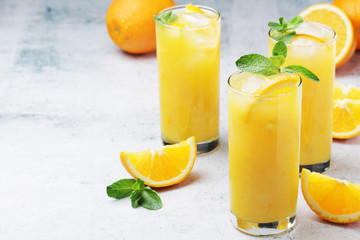 Glasses full of orange juice with ice