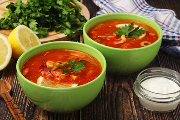 Two bowls with traditional Russian soup solyanka