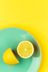 Minimal Photo of Yellow Lemon on Turquoise Dish