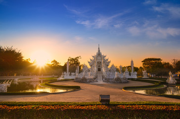 Wat Rong Khun in Chiang Rai Province, Thailand. The beautiful White Temple at sunset in north Thailand. 