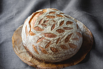 Beautiful, freshly baked natural sourdough bread. .Homemade bread with decorative notches