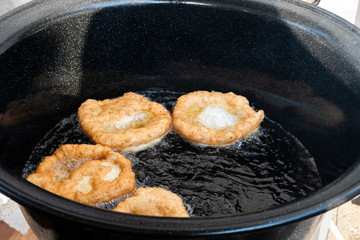 Chef preparing fried churros or donuts and pancakes during brunch buffet in the garden. Food Buffet Brunch Catering Dining Eating Party Sharing Concept
