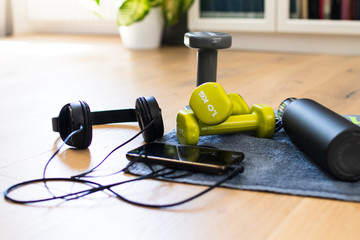 Gym at home, accessories for fitness at home. Tools for sport activities: towel, headphone, mobile phone, dumbbell and water tank. Vintage colors