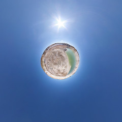 Little planet transformation of spherical panorama 360 degrees. Spherical abstract aerial view in field with awesome beautiful clouds. Curvature of space.
