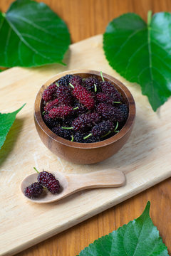 Fresh mulberry fruit on wood table background