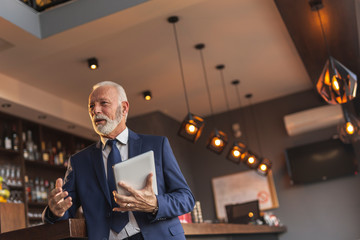 Senior businessman having conversation with colleague