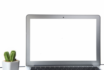 Fototapeta premium White screen computer and cactus plant on the table on white background, copy space input text concept and smart technology idea