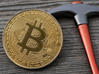 Bitcoin and Pickaxe on Wooden Background, BTC Physical Coin