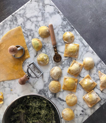 Filled ravioli pasta making at home on the marble table background