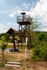 Lookout tower in small village Nov&aacute; Ves u Kdyně, Sumava, Bohemian Forest, B&ouml;hmerwald, Czech Republic. Wooden signpost.