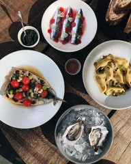 Delicious seafood lunch spread with oysters, pasta, sardines and cod