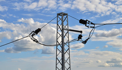 electricity pylon against blue sky