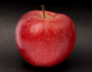 Red apple on black background