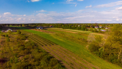 Fototapeta na wymiar Shot from the drone on the green Polish agricultural fields