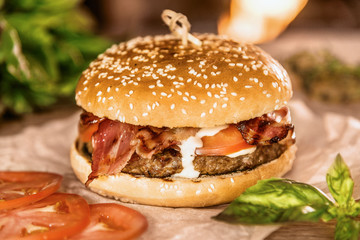 Appetizing hamburger on a table among vegetables