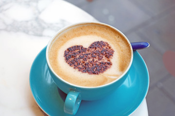 Delicious latte coffee with chocolate heart