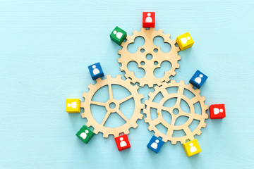 image of colorful blocks with people icons over wooden table ,human resources and management concept